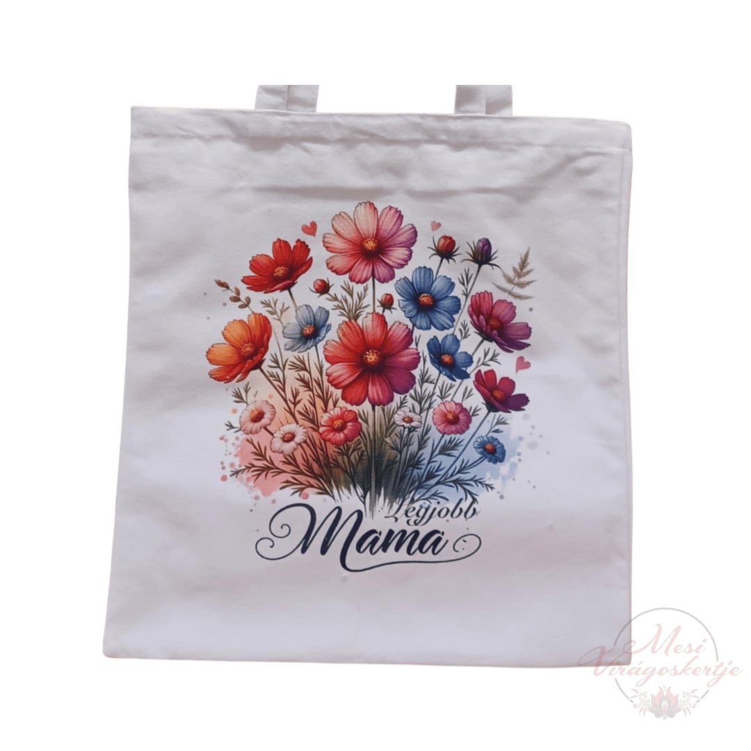Fehér vászontáska két füllel, elején színes virágmintával és „Legjobb Mama” felirattal.
